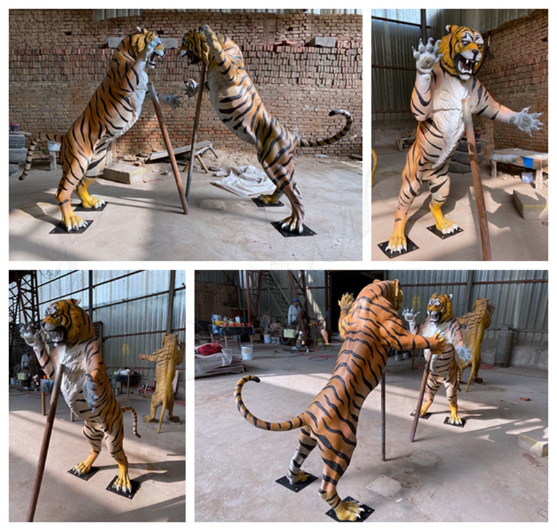 A pair of fighting bronze tiger sculptures completed display