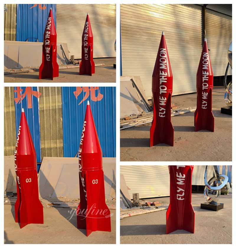 a pair of red stainless steel rocket sculptures