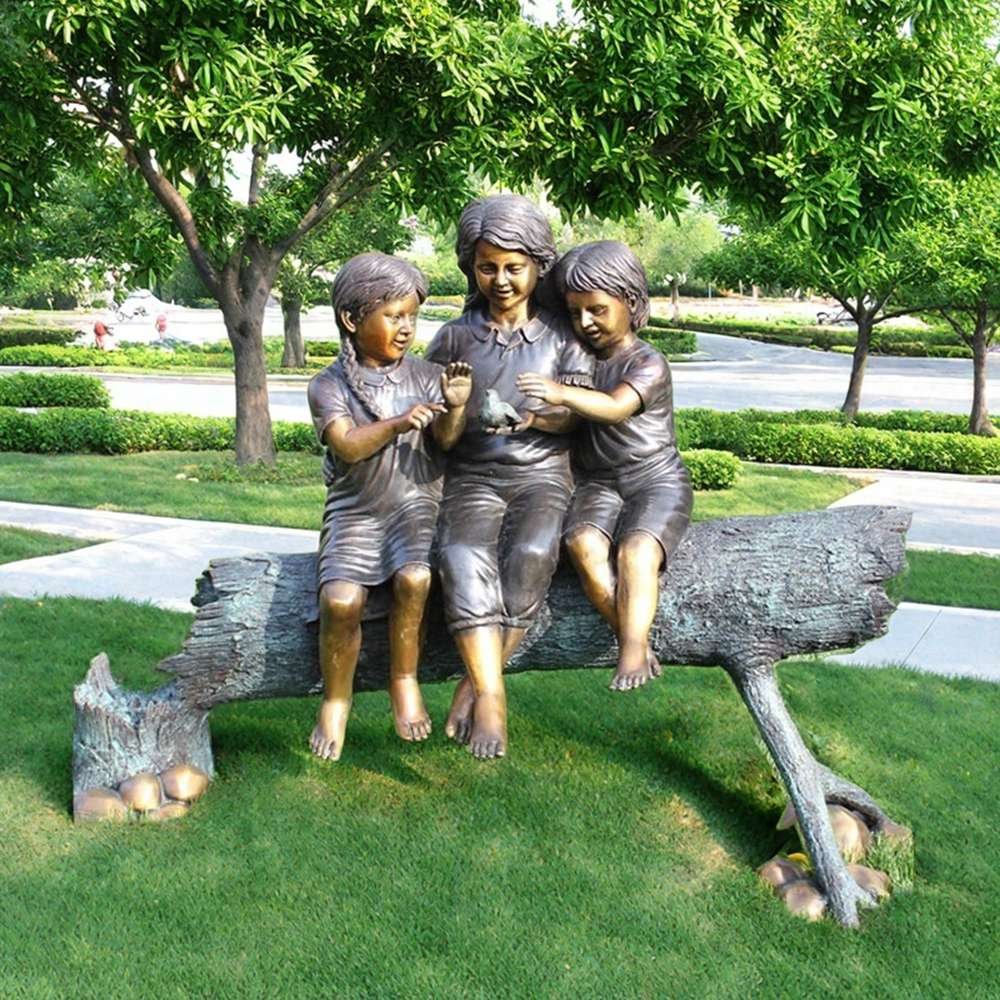 bronze girls sitting on a trunk sculpture for park decor