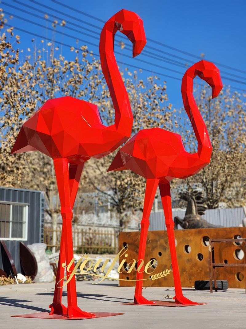 large red metal flamingos