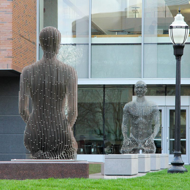 stainless steel figure sculptures on the campus